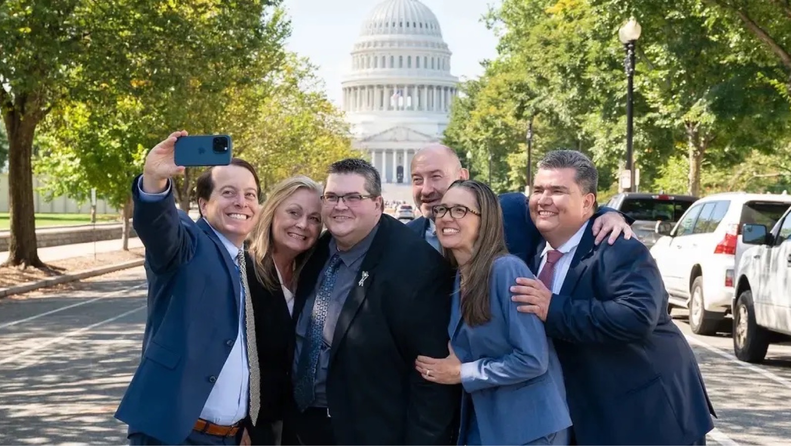 eBay President and CEO Jamie Iannone takes a selfie with a group of sellers in Washington, D.C.