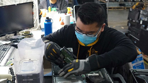 human I T technologist refurbishing electronics